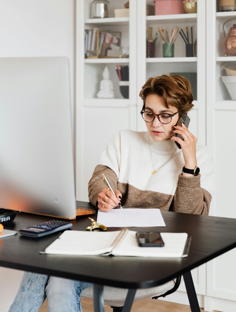 Individual reviewing personal tax documents at a home office desk in Oxfordshire