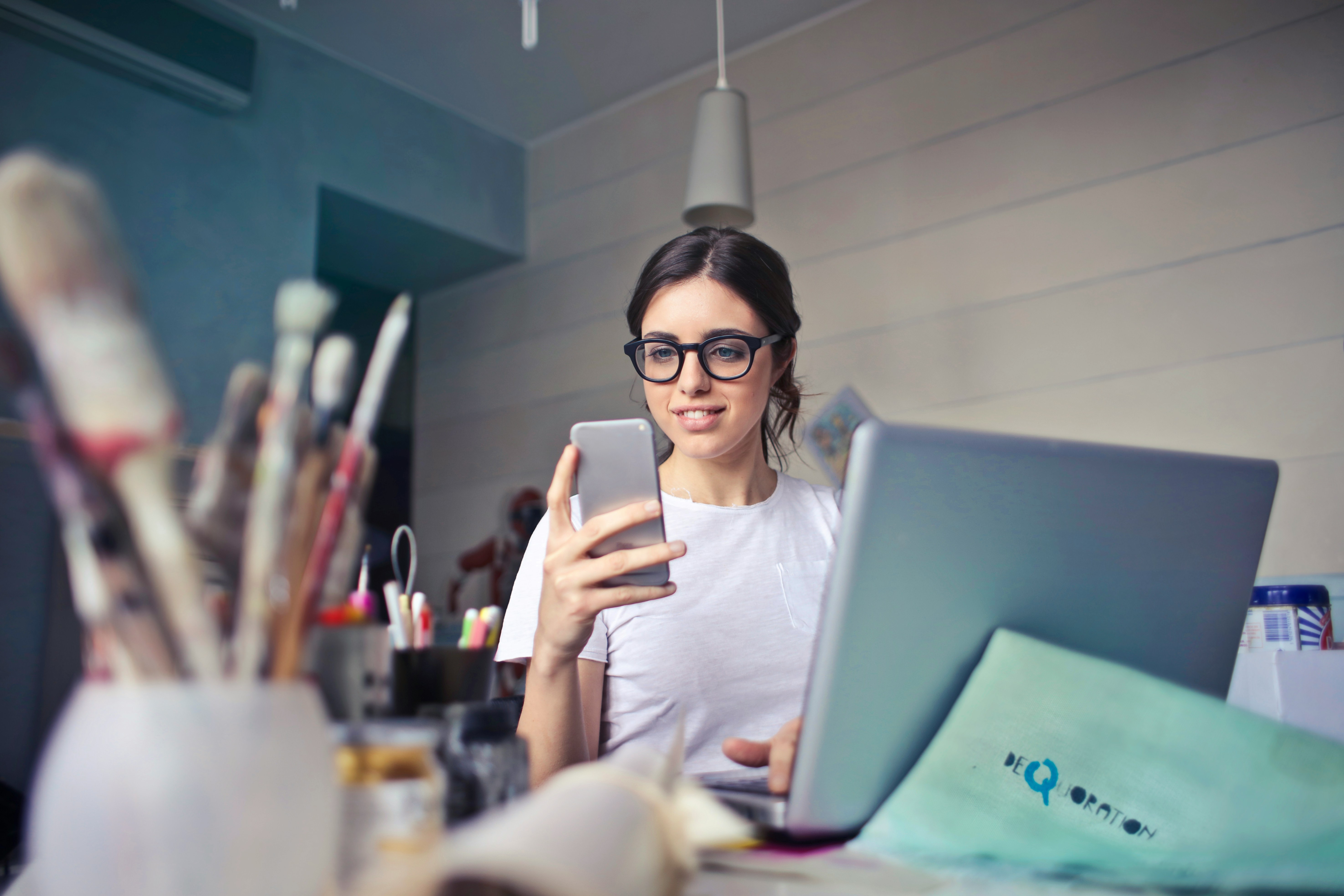 Creative professional woman submitting self-assessment tax return on her phone