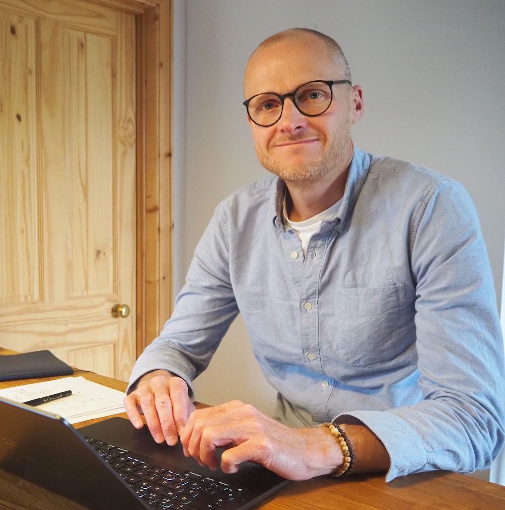 Simon Maughan, chartered accountant, working at his desk